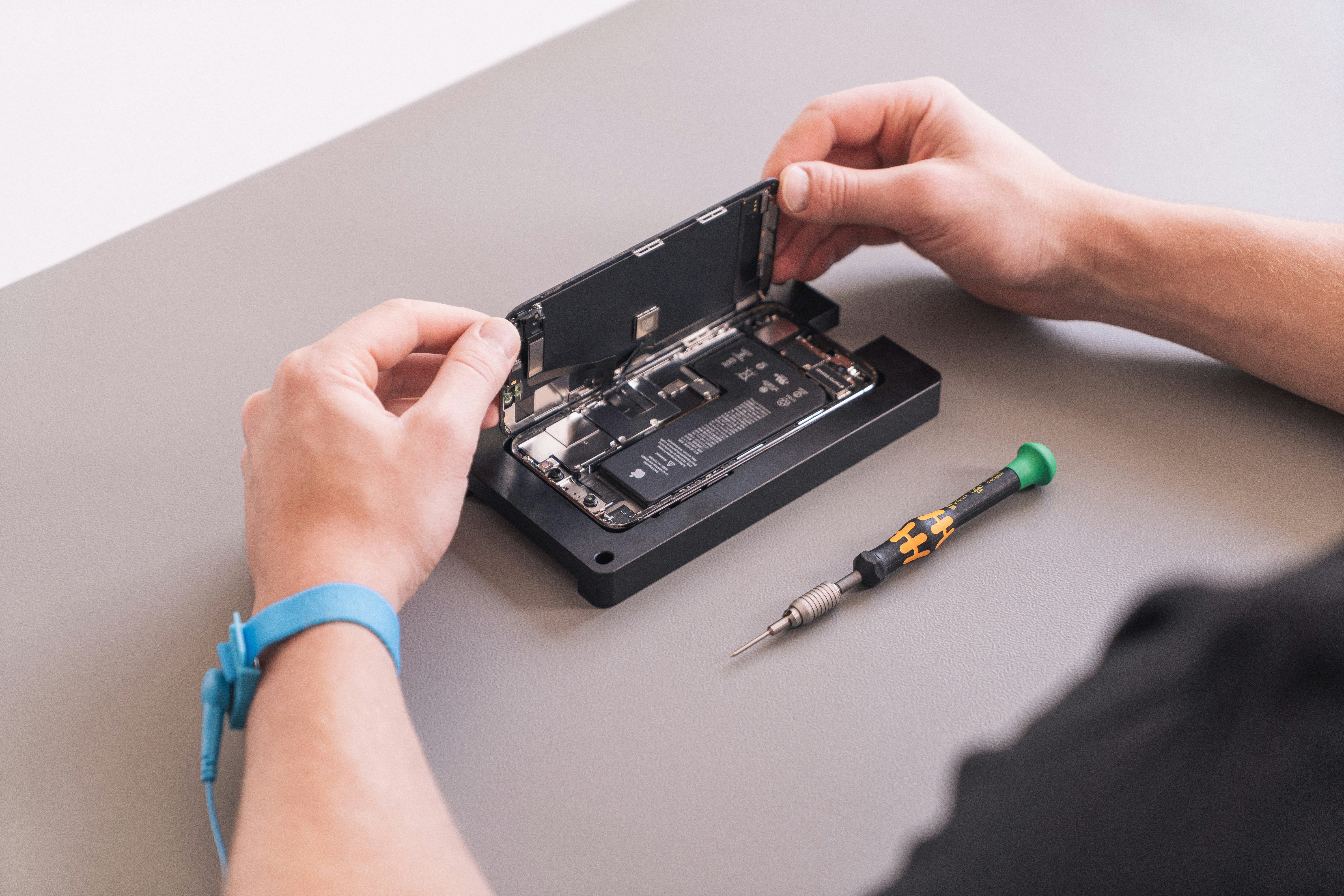 technician hands installing modular circuit components in a repairable laptop chassis
