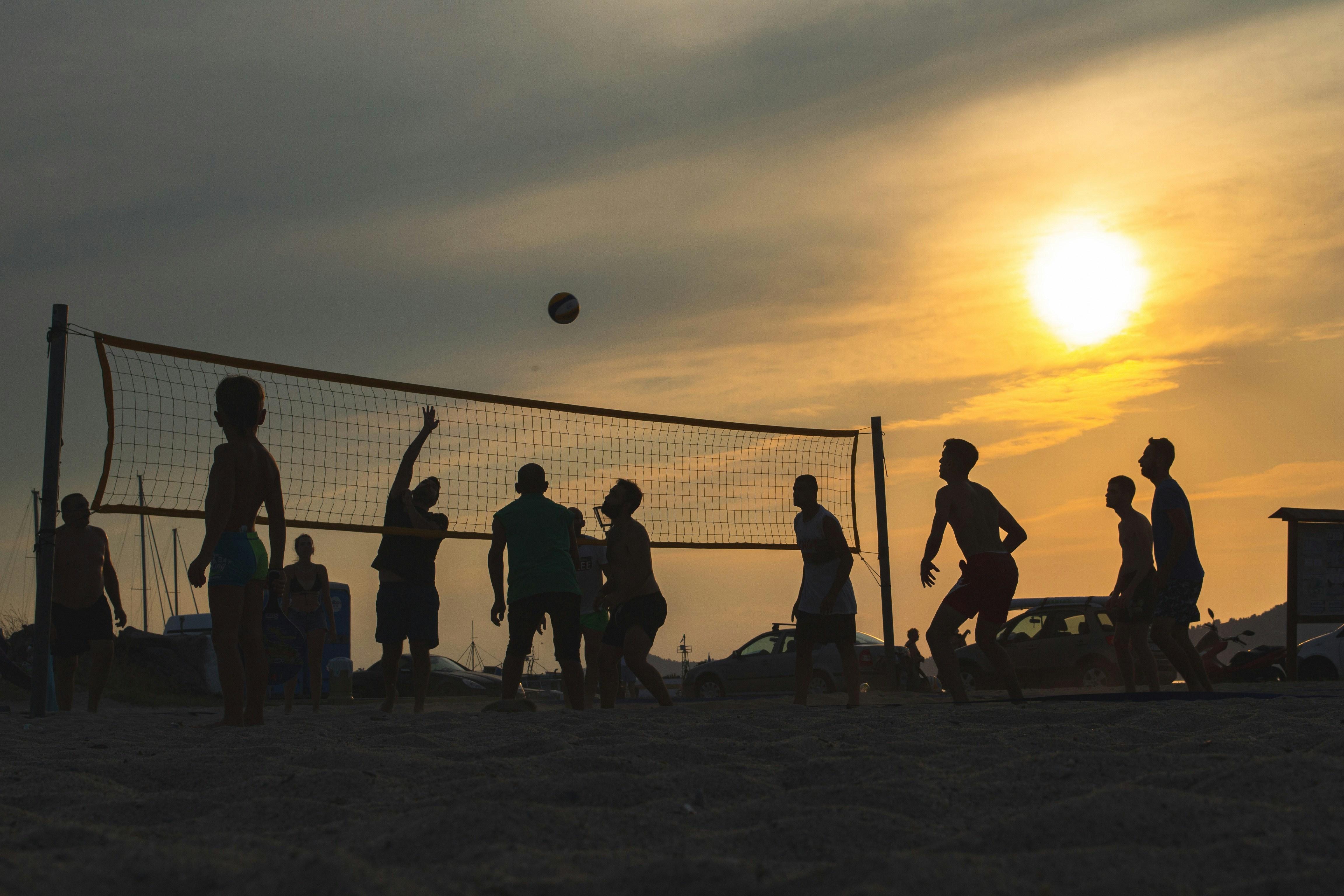 a group of people playing volleyball