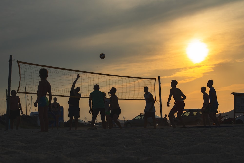 a group of people playing volleyball