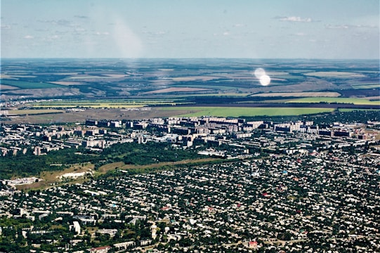 An aerial view of diverse economic zones with marked areas for agriculture and technology.