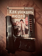 Hands holding a neatly printed copy of Delaware firearm statutes on a clean desk.