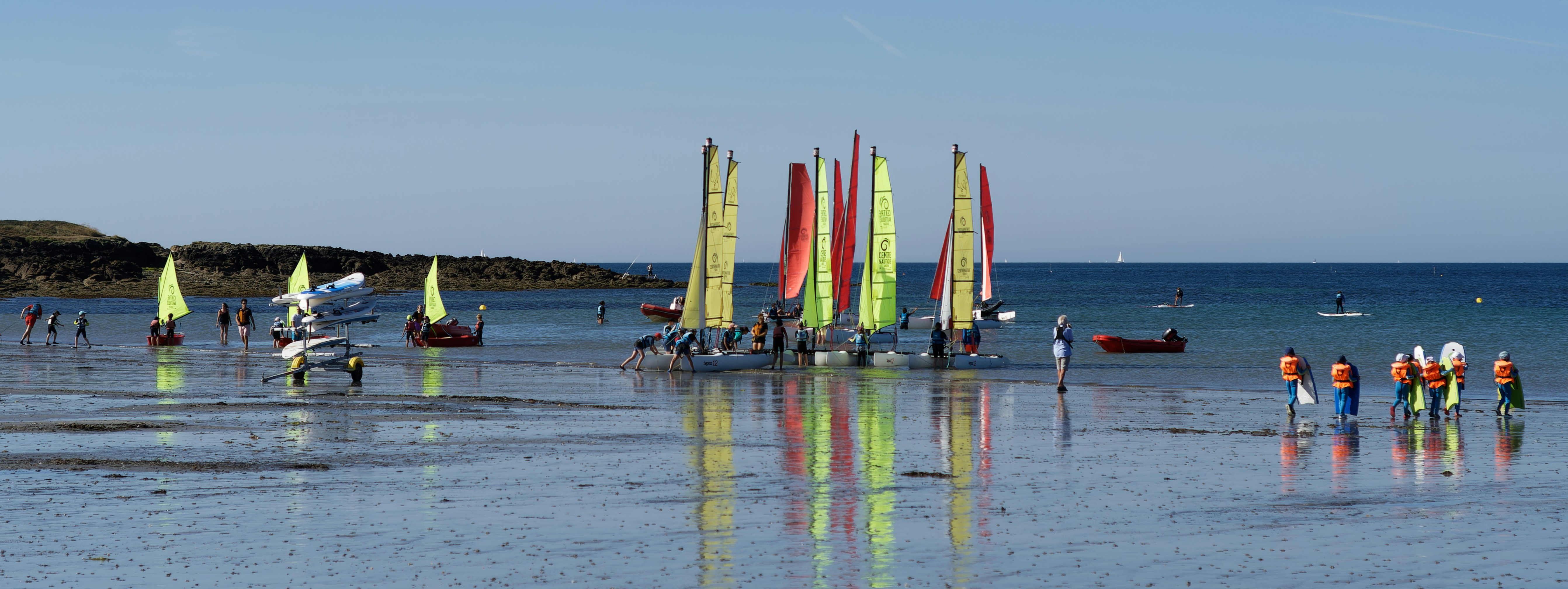 a group of people stand on a beach