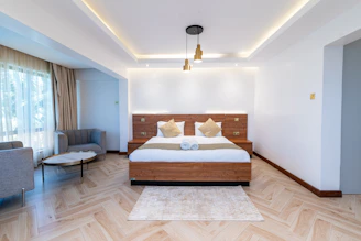 a bedroom with a bed and a chair