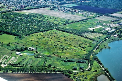 Aerial view of a flat land parcel near a small lake.