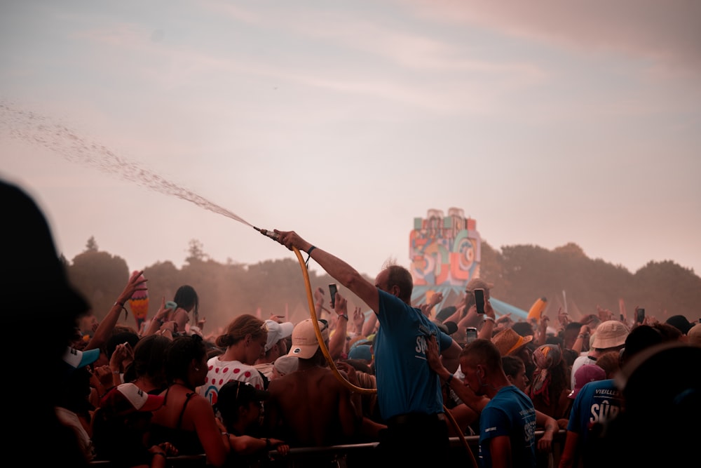 a man holding a stick in front of a crowd of people