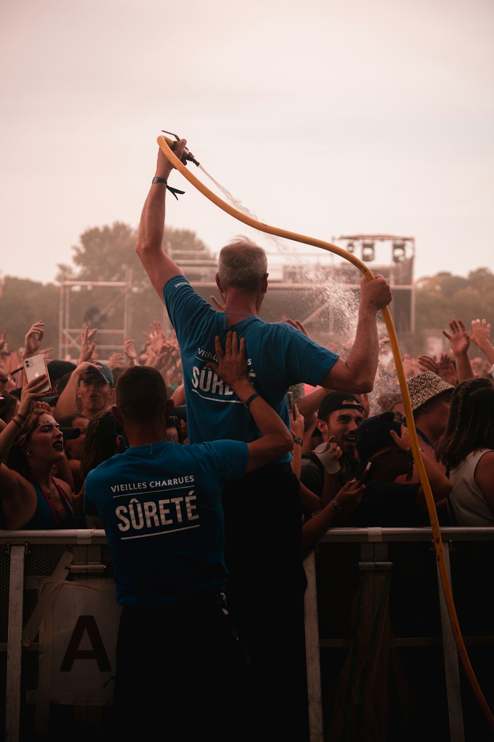 a man holding a stick in front of a crowd