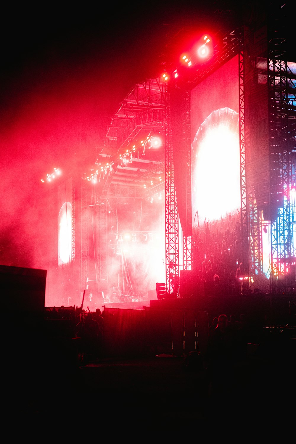 a stage with lights and a crowd of people in front of it