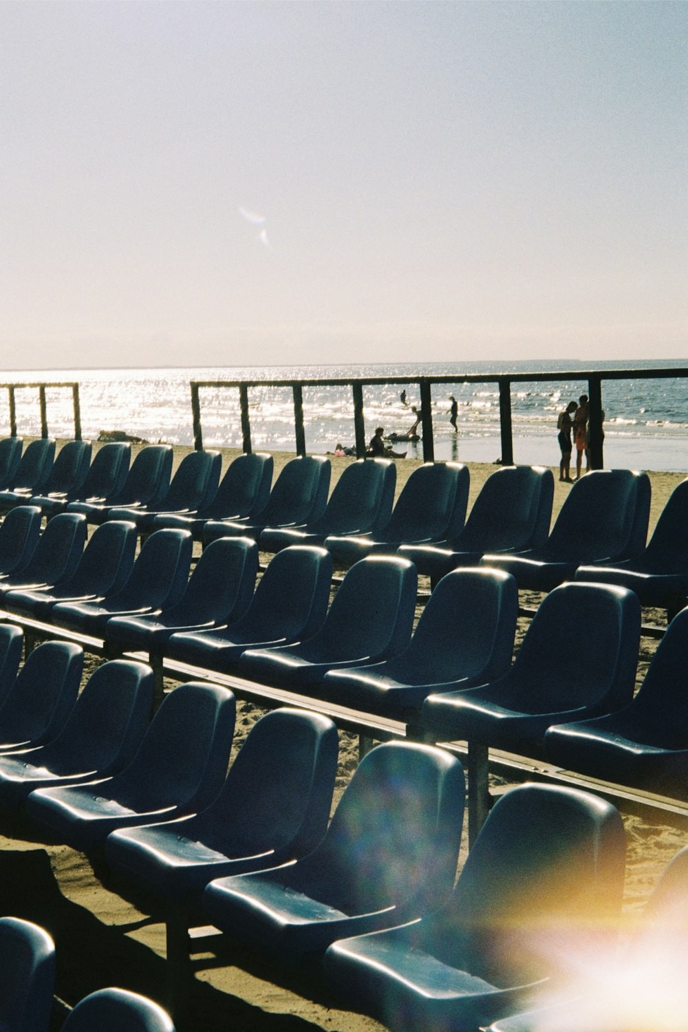 rows of empty chairs on a beach