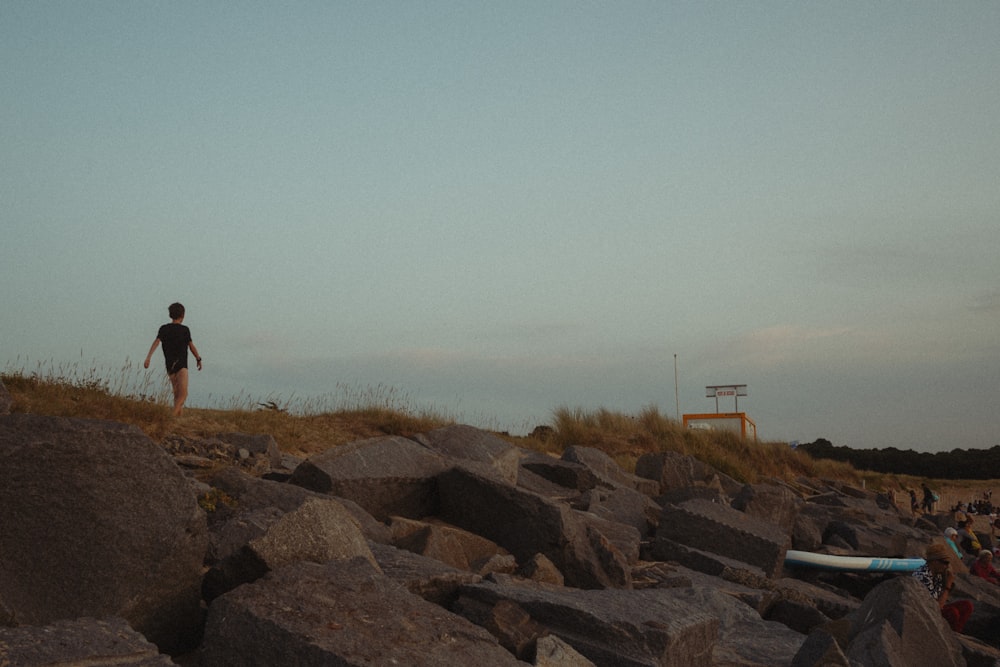 a person standing on a rocky hill