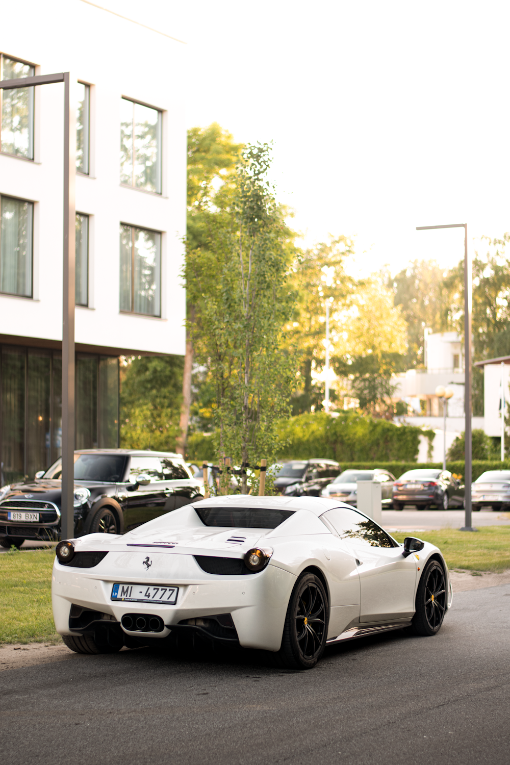 a white sports car parked on the side of a road