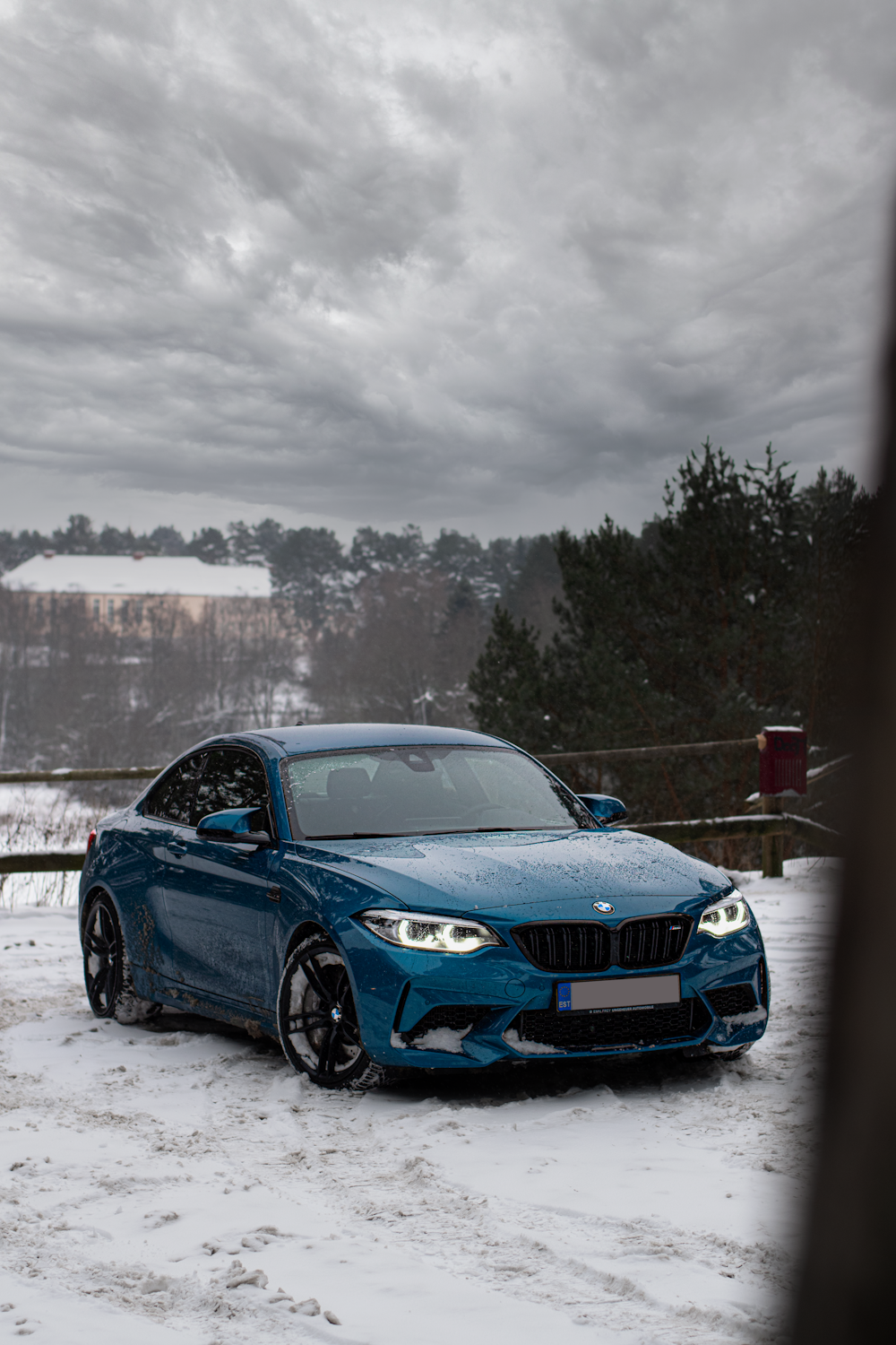 a blue car parked in the snow