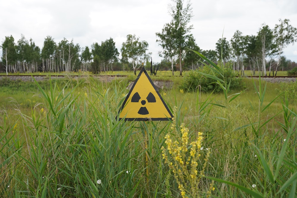 a yellow sign in a field