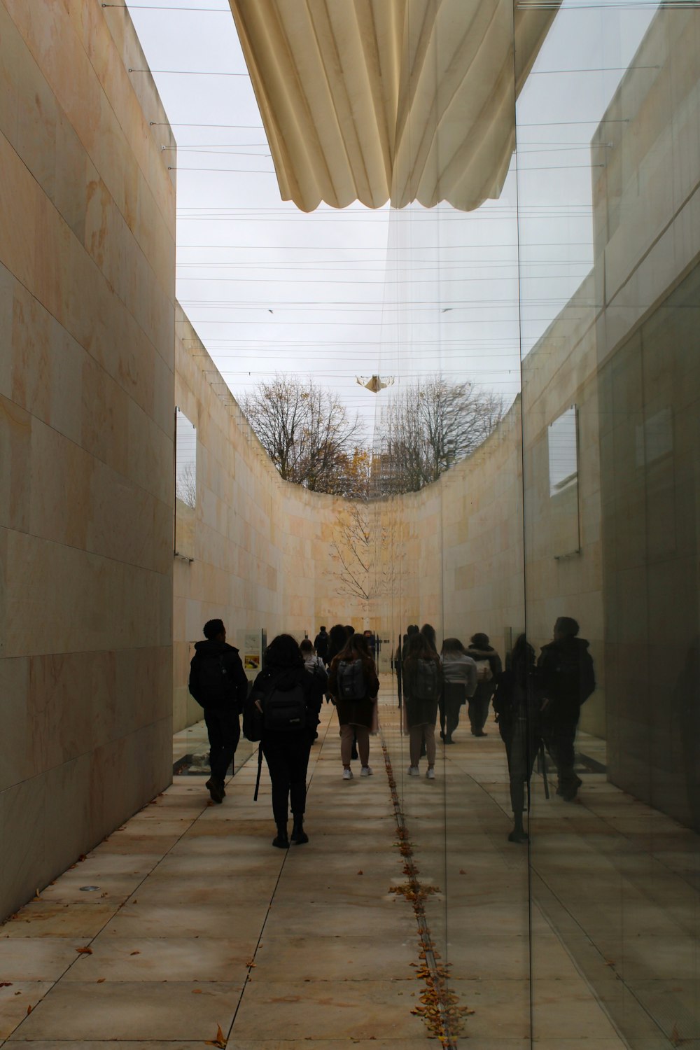 a group of people walking down a sidewalk