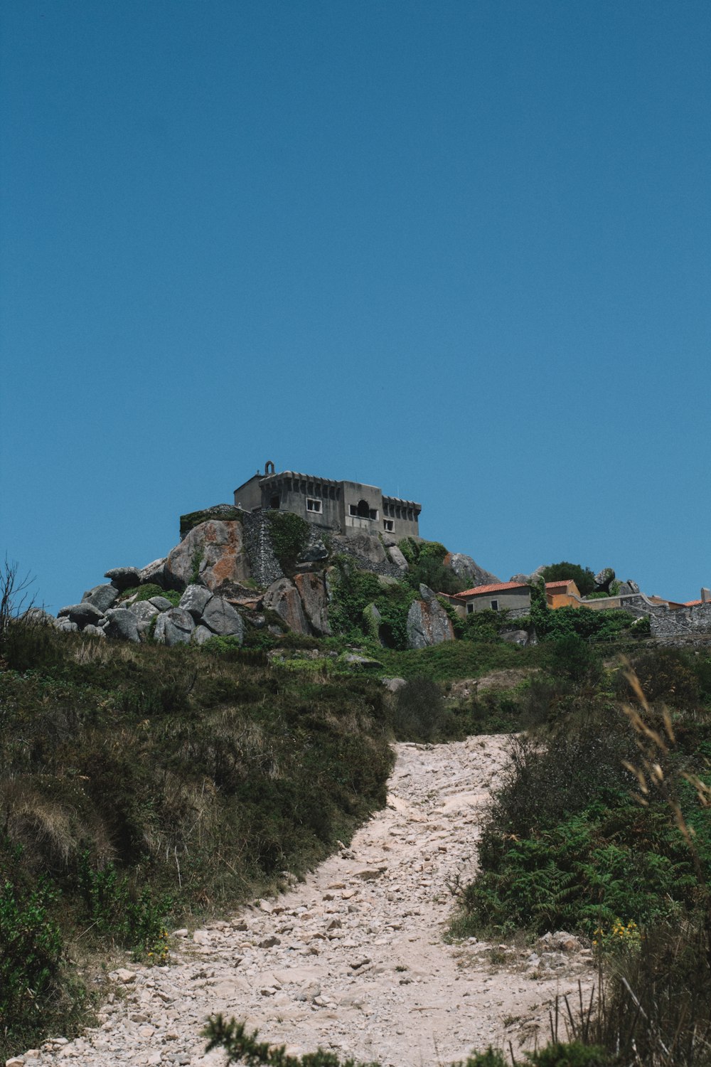 a stone building on a hill
