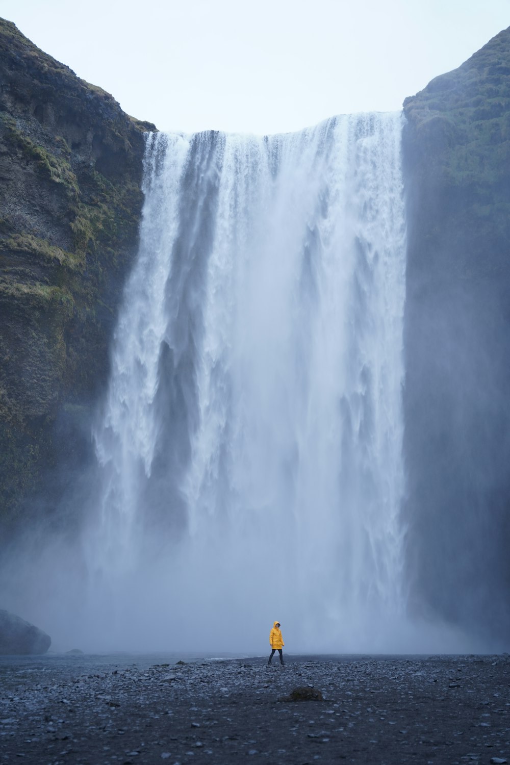 a person standing in front of a waterfall