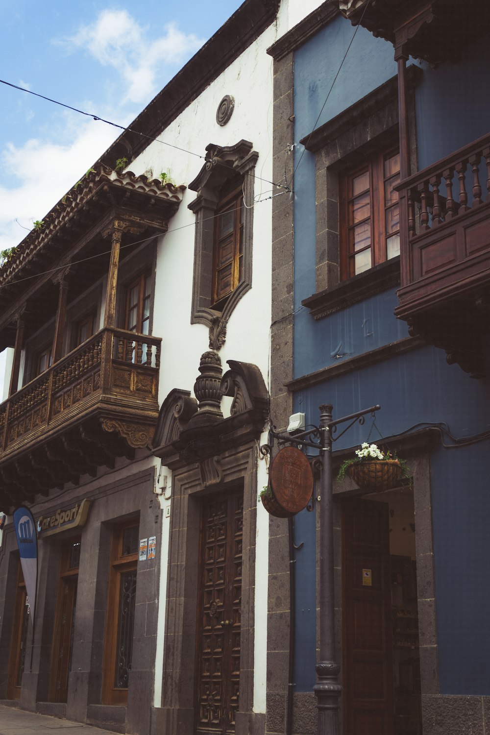 a row of buildings with balconies and a clock