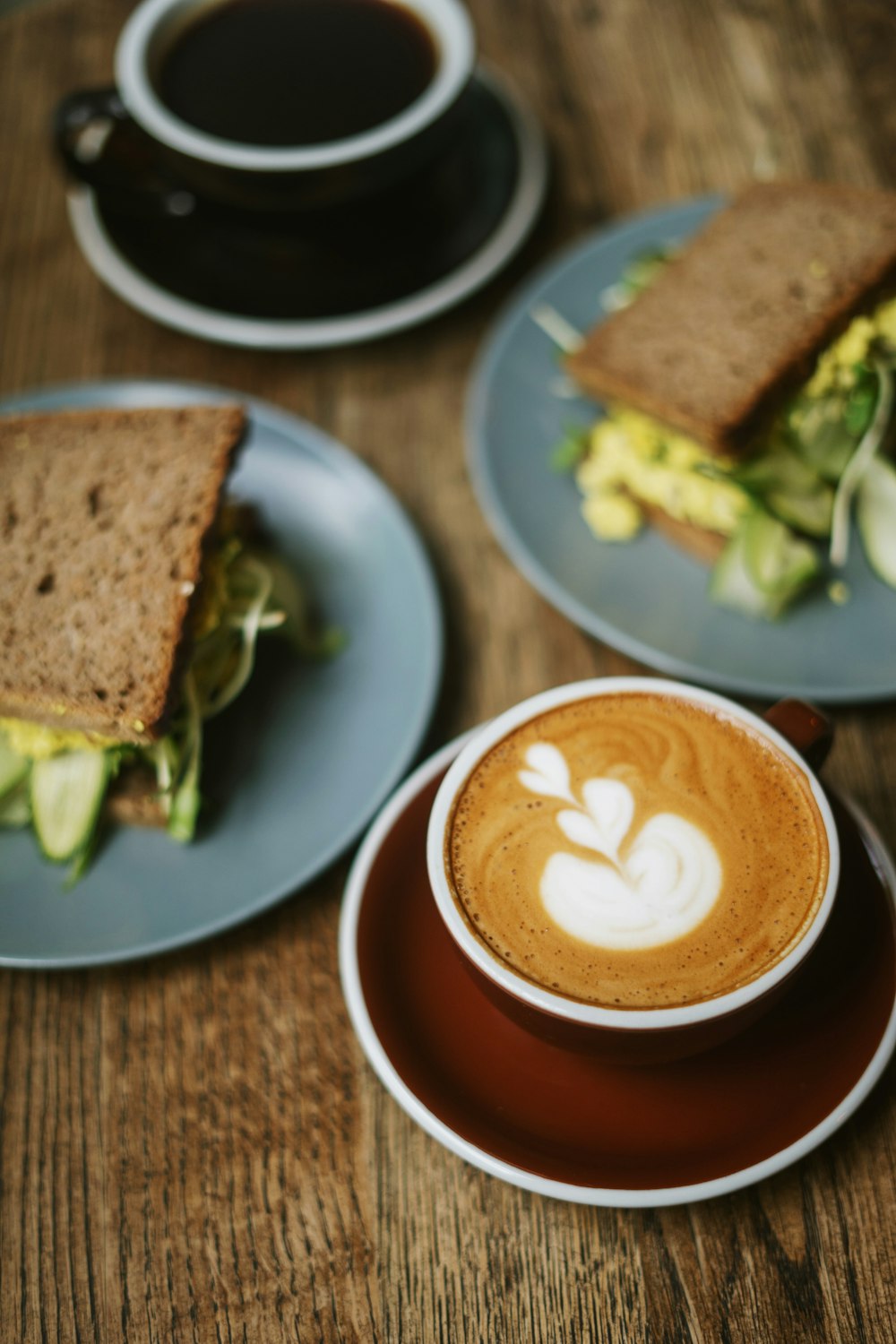 a table with plates of food and a cup of coffee