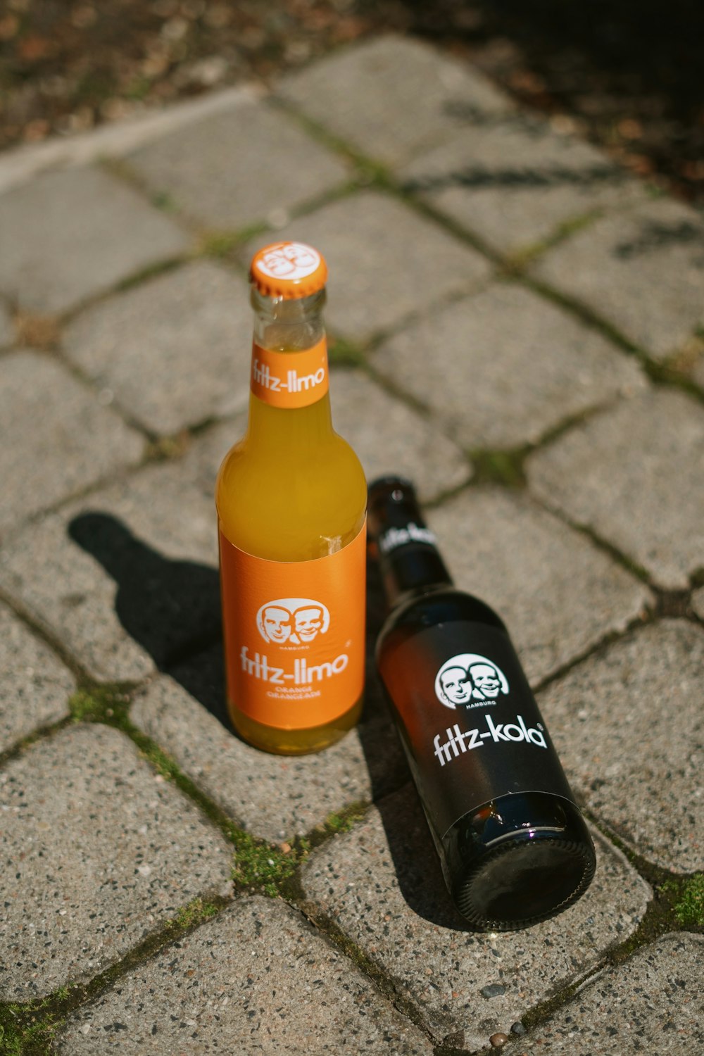 two bottles of beer on a stone surface
