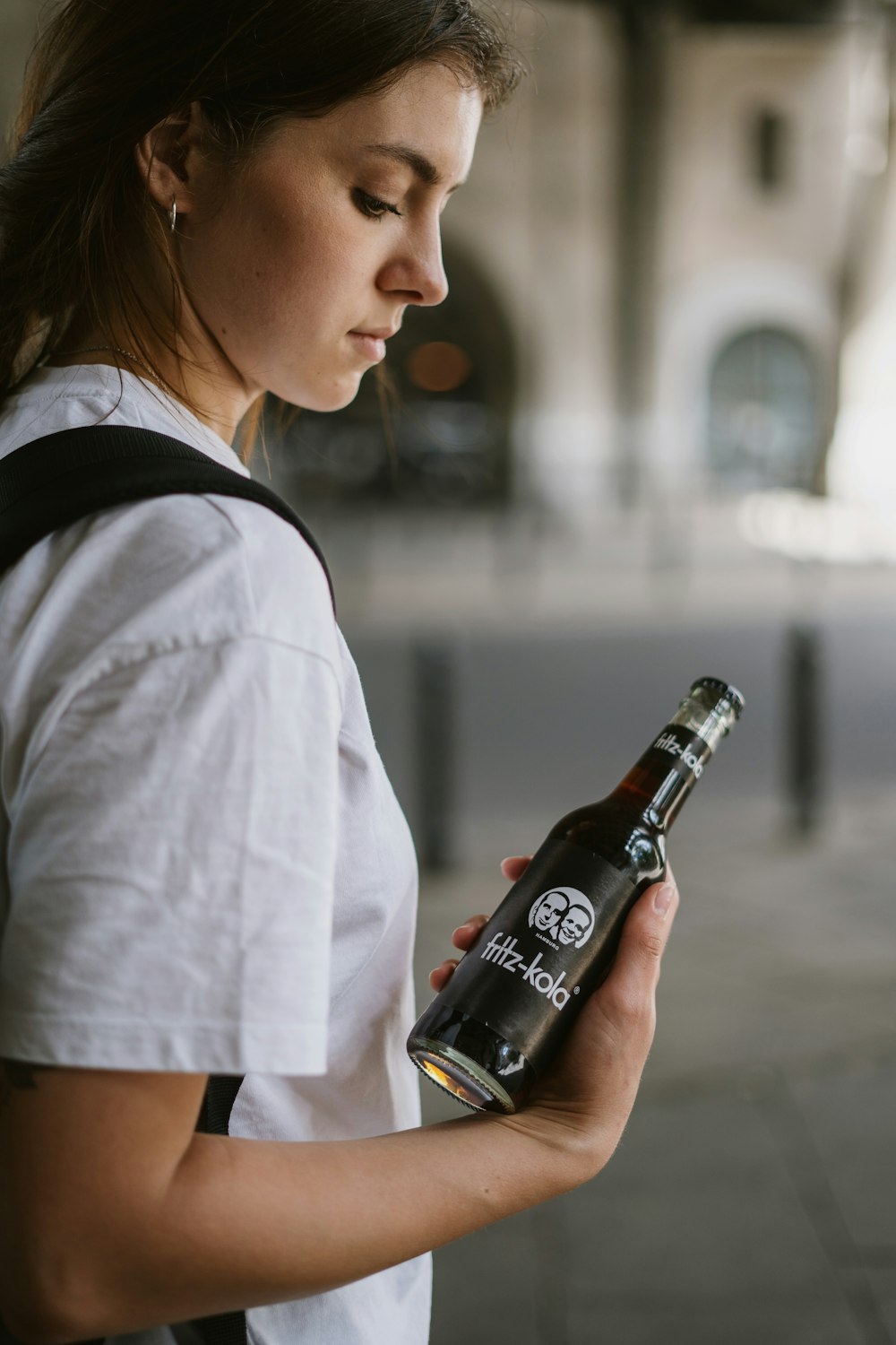 a woman holding a bottle of alcohol