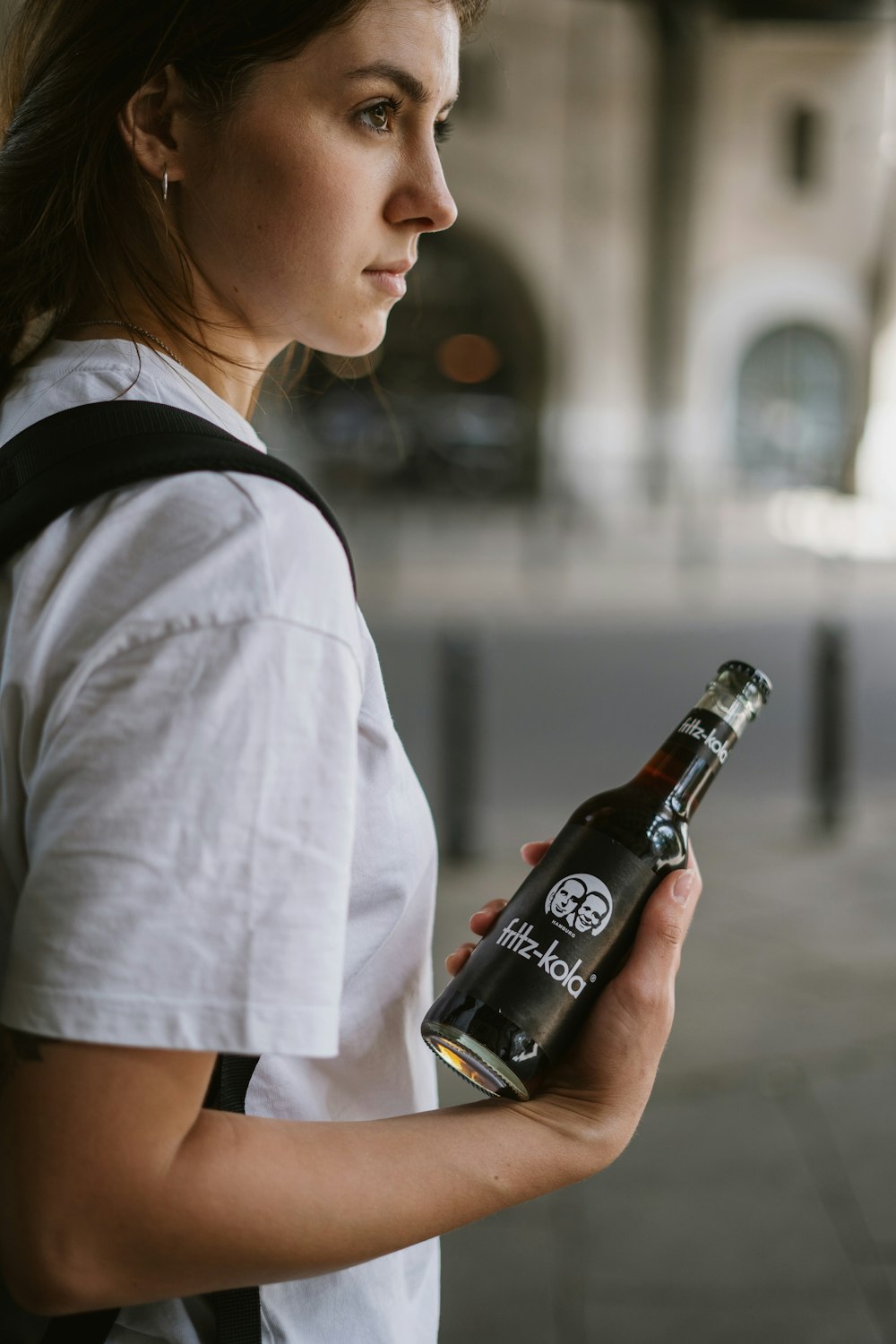 a woman holding a bottle