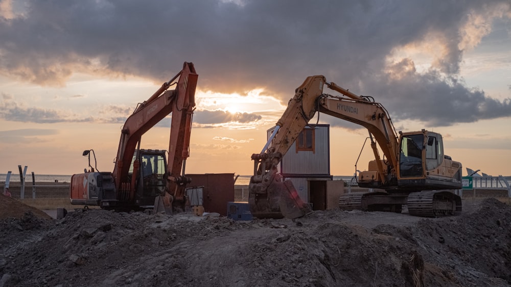 a few construction vehicles in a dirt field