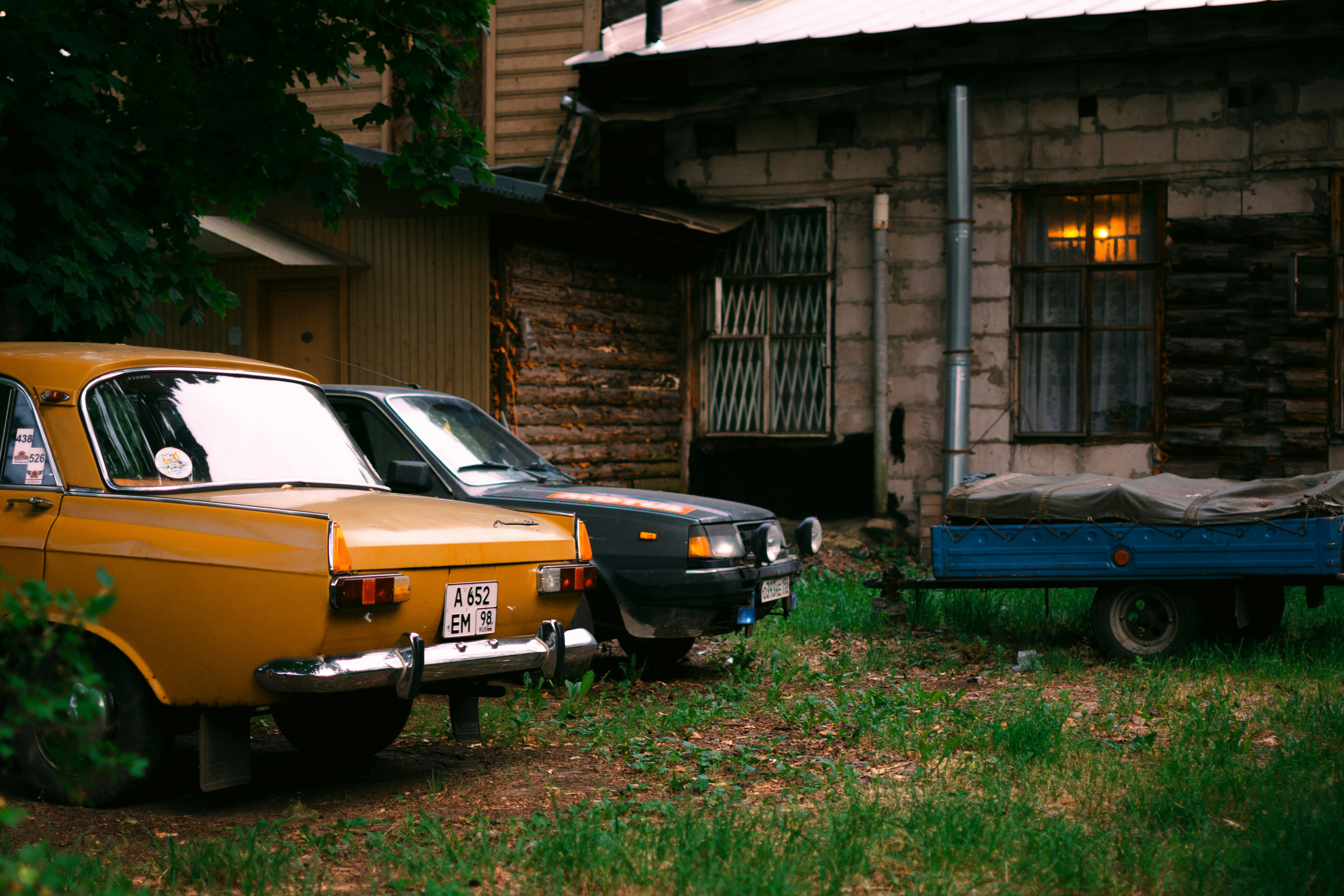a couple of cars parked in front of a house