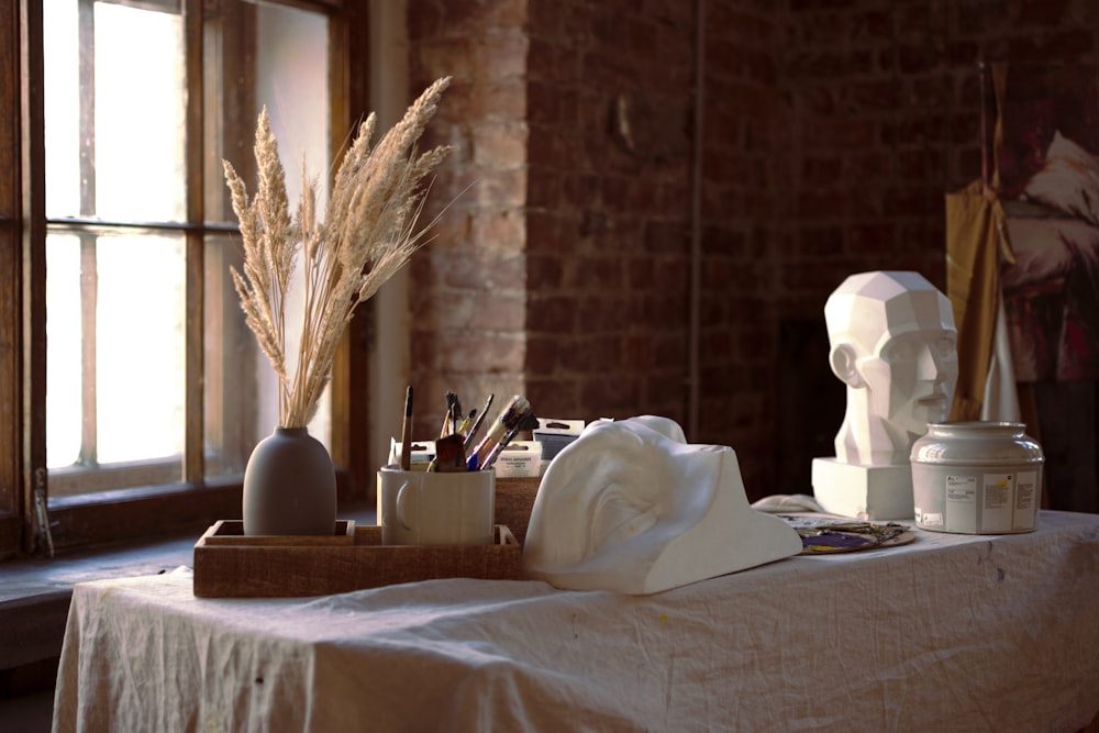 a table with a vase and objects on it