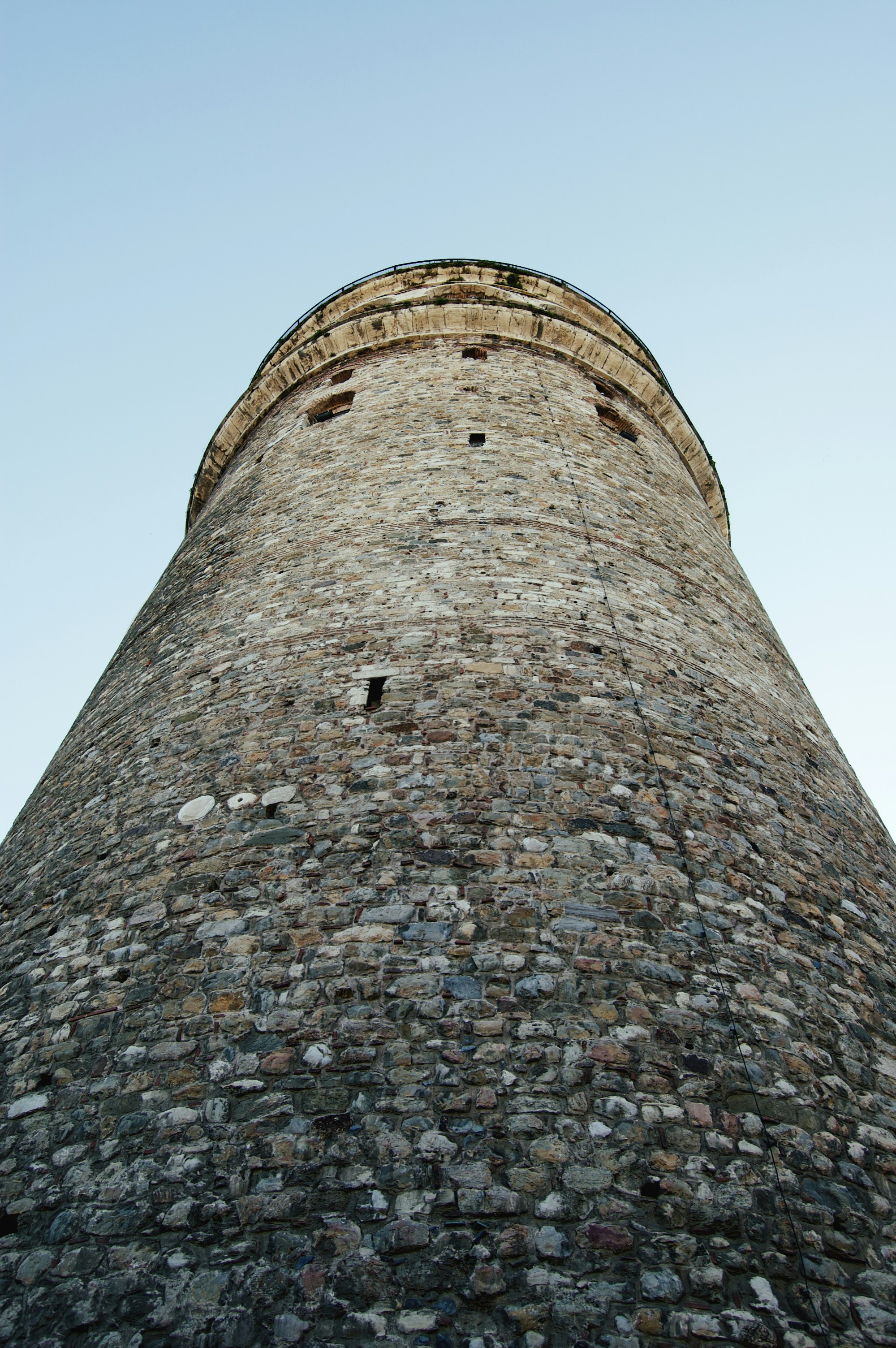 a stone tower with a stone wall