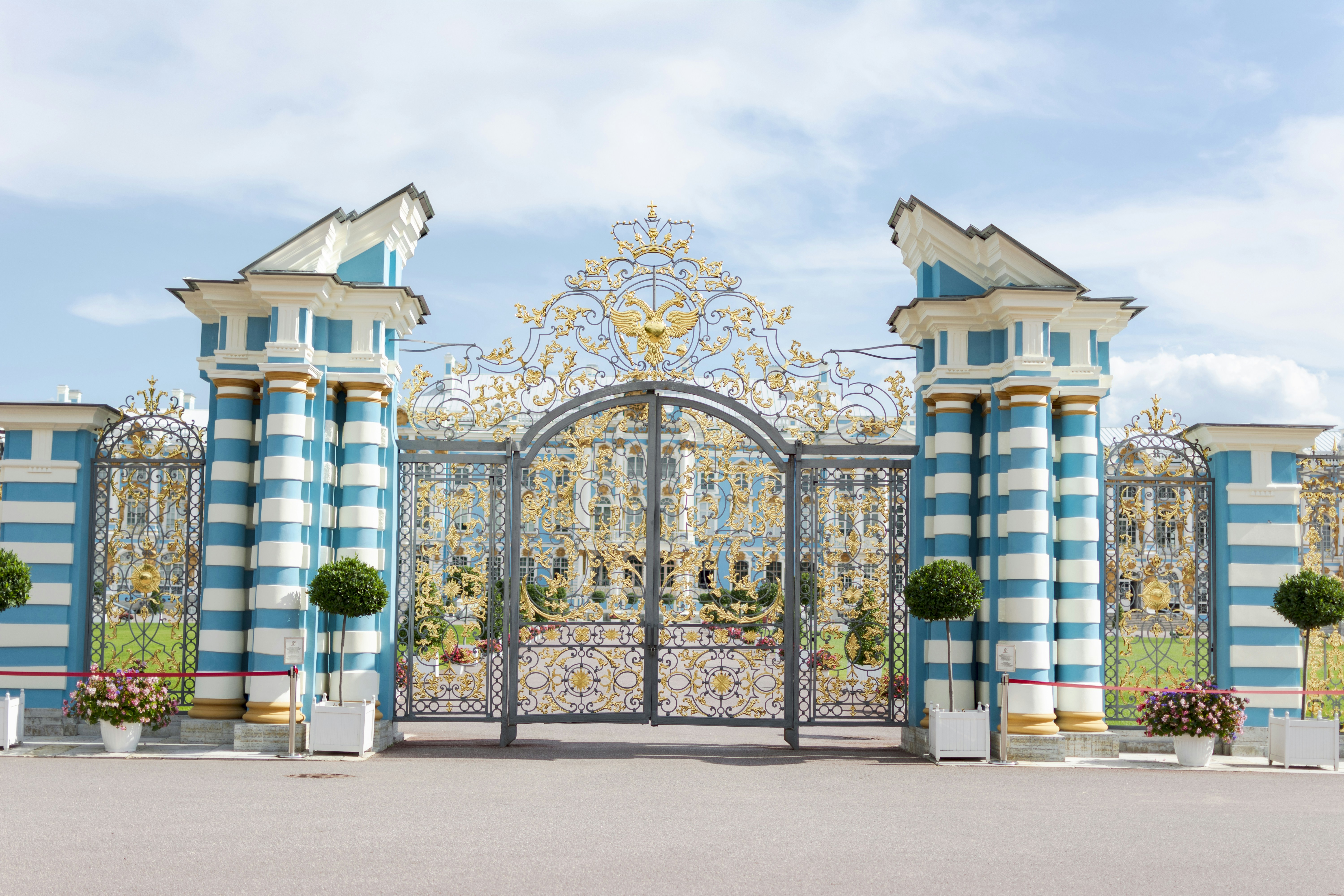 a gate with a gate and Tsarskoye Selo in the background