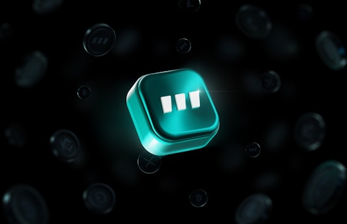 A luminous three-dimensional teal cube with three white vertical bars in the center, floating against a dark background. Multiple faint circular shapes with various symbols surround it, suggesting a digital or technological theme.
