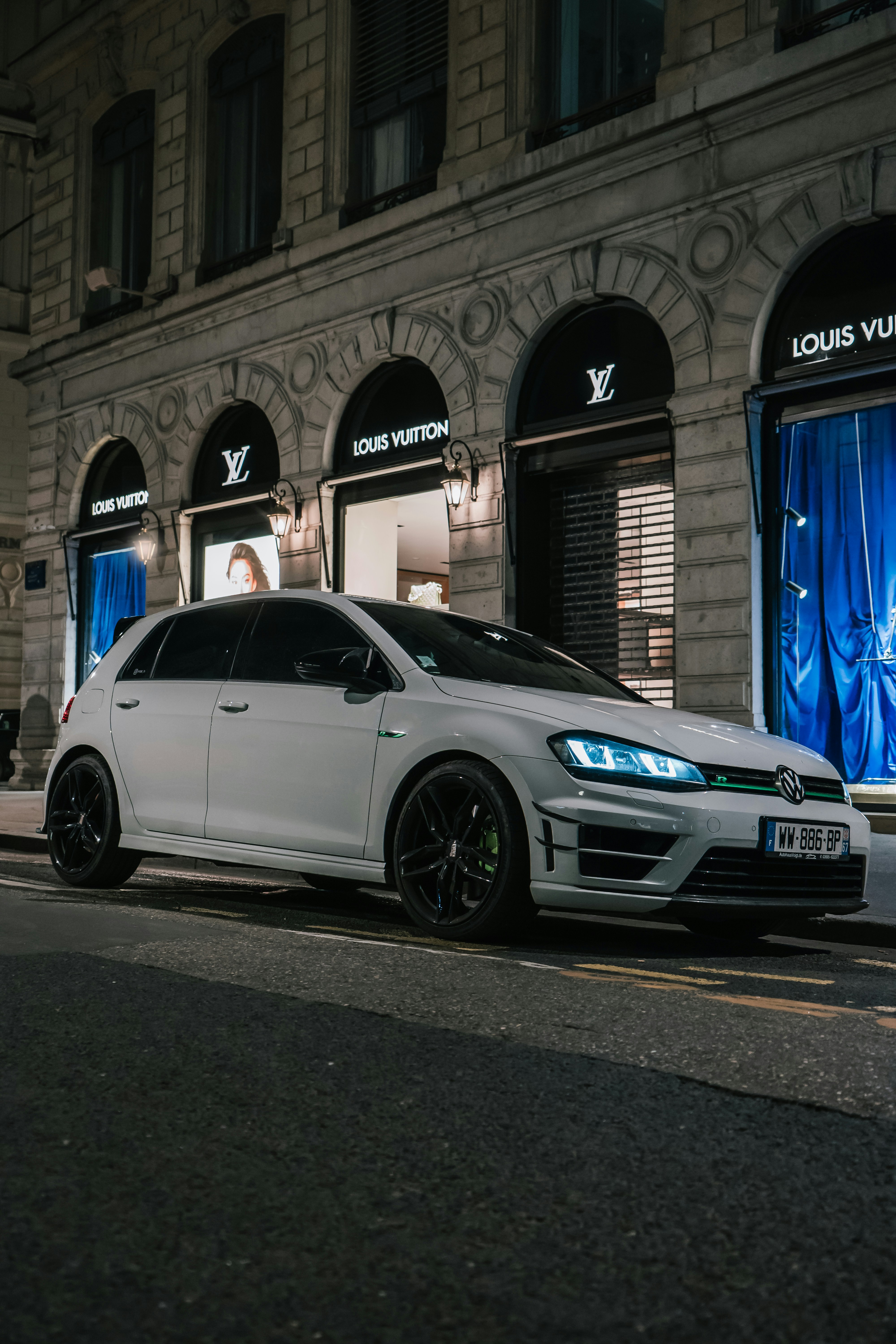 a silver car parked in front of a building