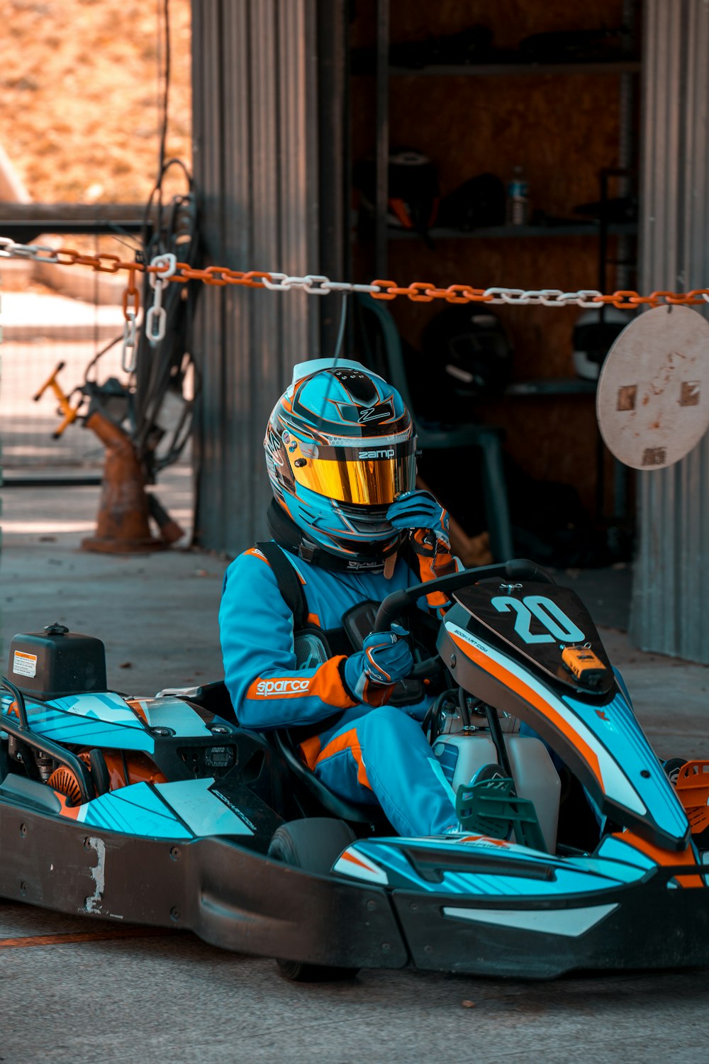 a person in a blue and yellow go kart