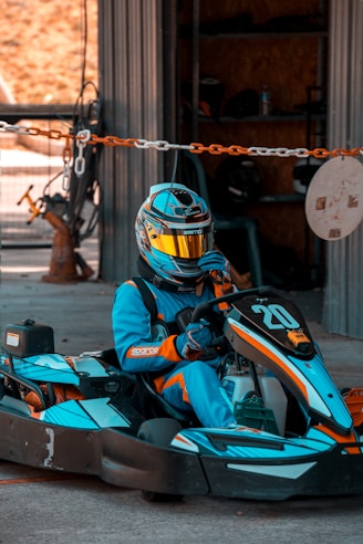 a person in a blue and yellow go kart