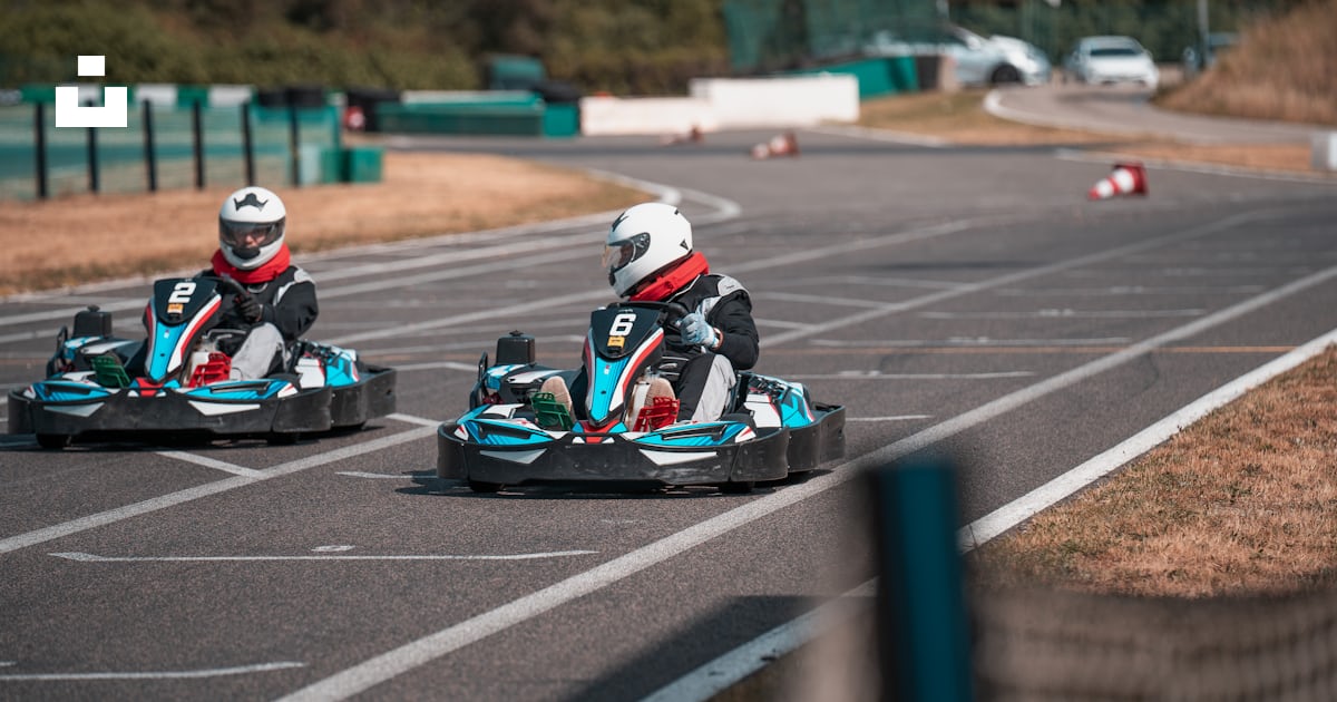 A group of people racing go carts photo – Free Kart Image on Unsplash