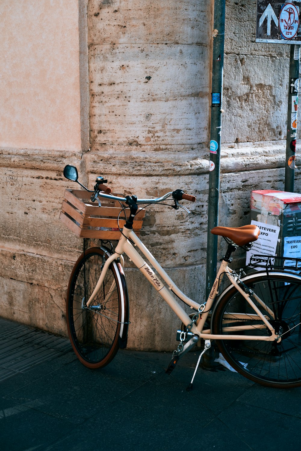 a bicycle parked next to a pole