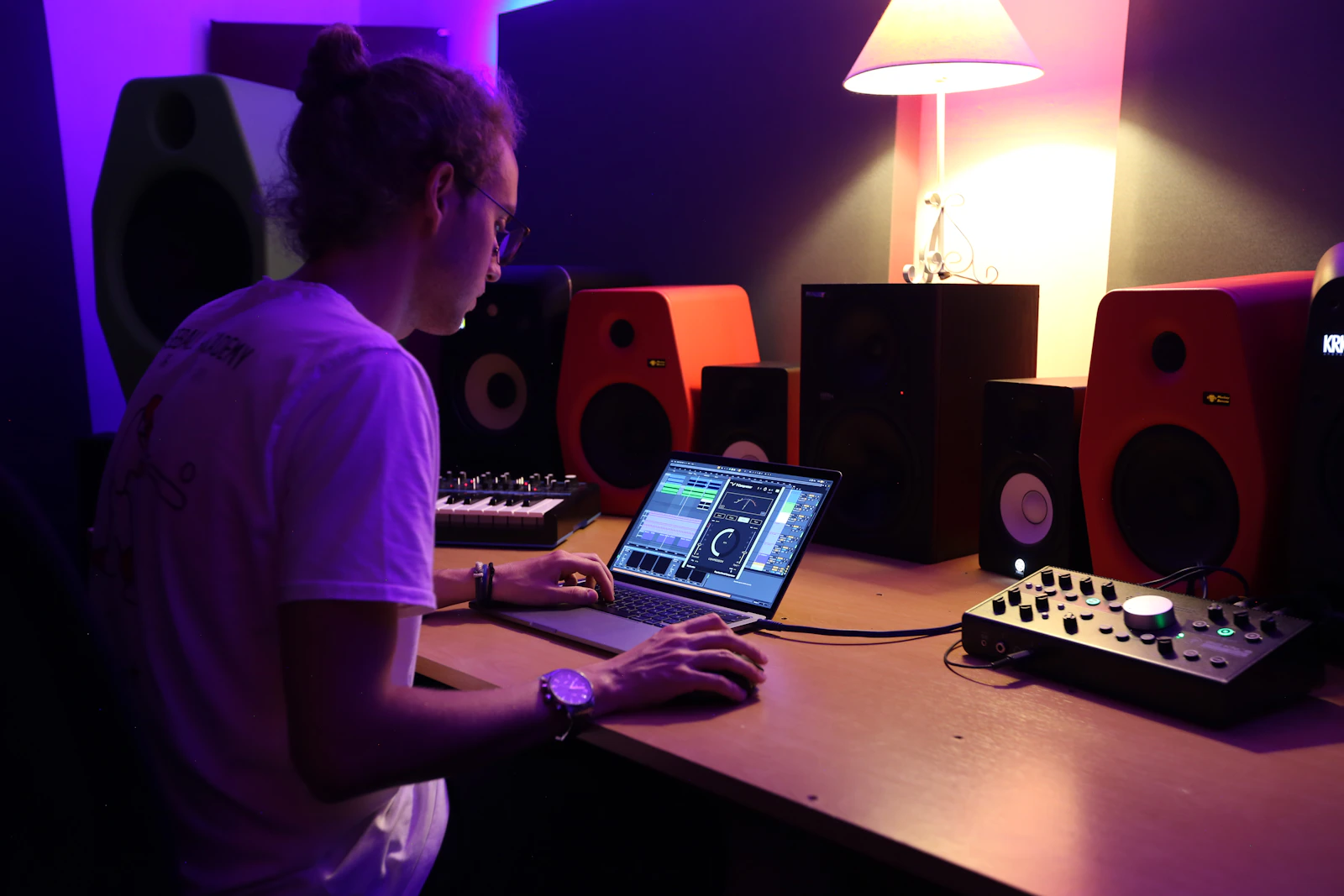 Musisi bekerja di depan laptop dalam studio untuk merapikan EPK, aset media, dan informasi booking