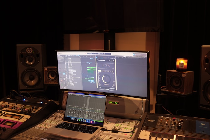 Professional surround sound mixing studio with speaker array visible and mixing console in foreground