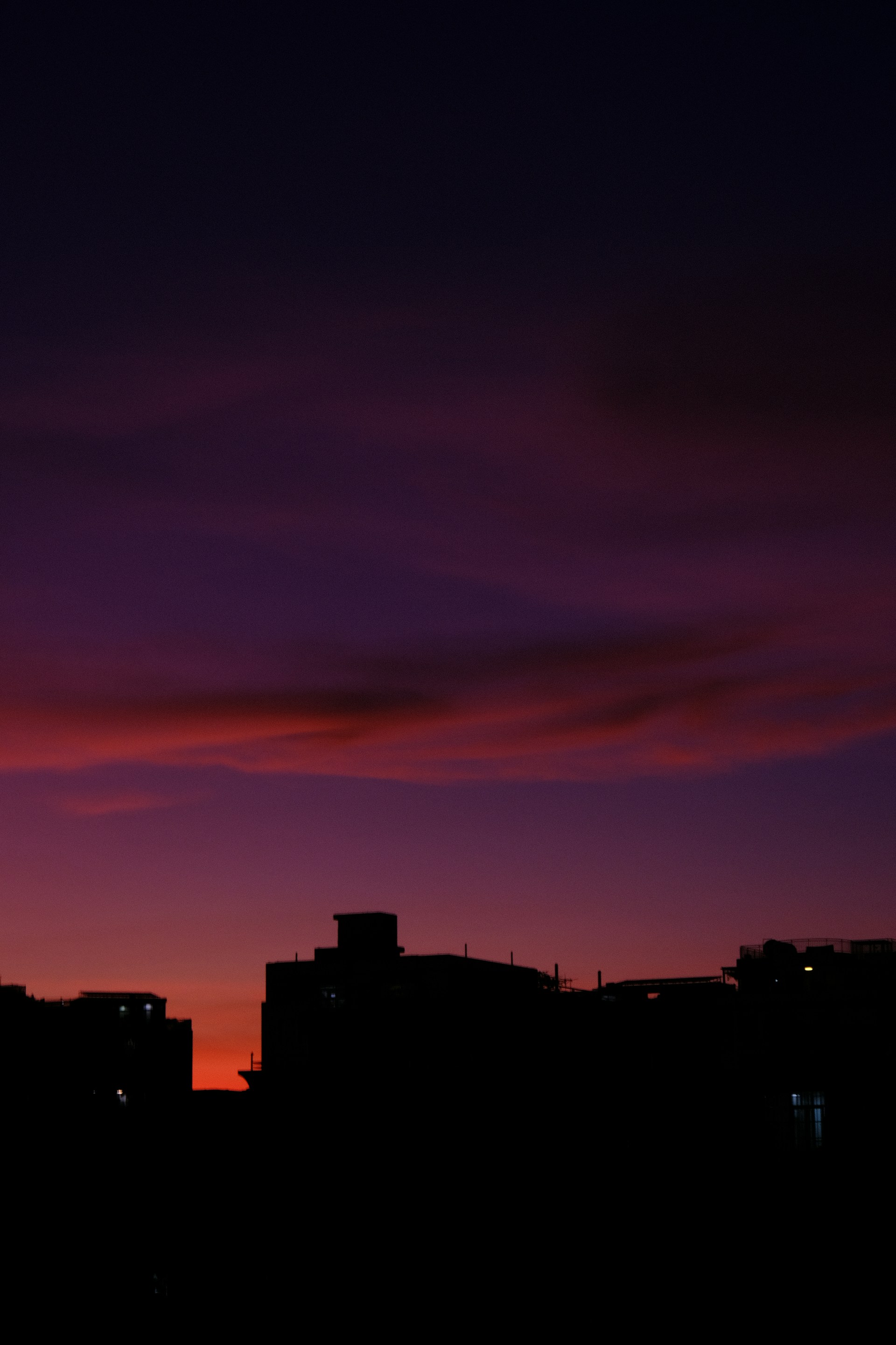 a silhouette of a city at night