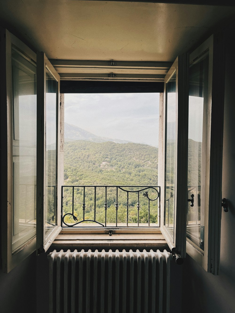 a balcony with a view of a valley and mountains