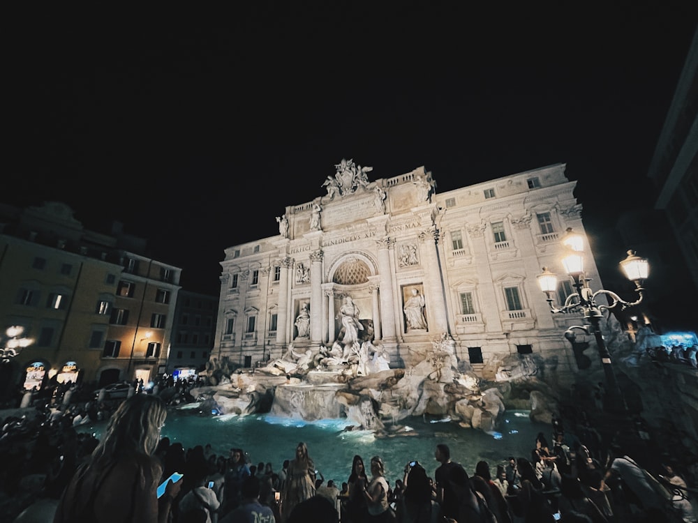 a large building with a fountain in front of it