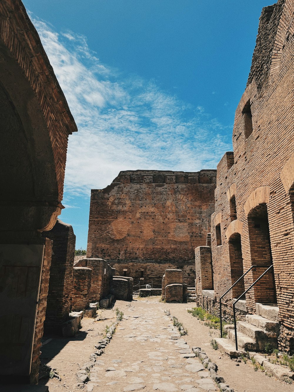 a stone road between two stone buildings