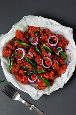a plate of authentic chicken 65 , plating photo