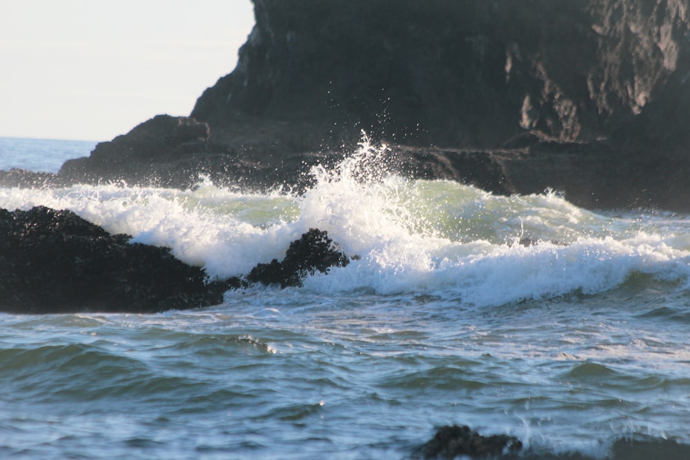 waves crashing against a rock