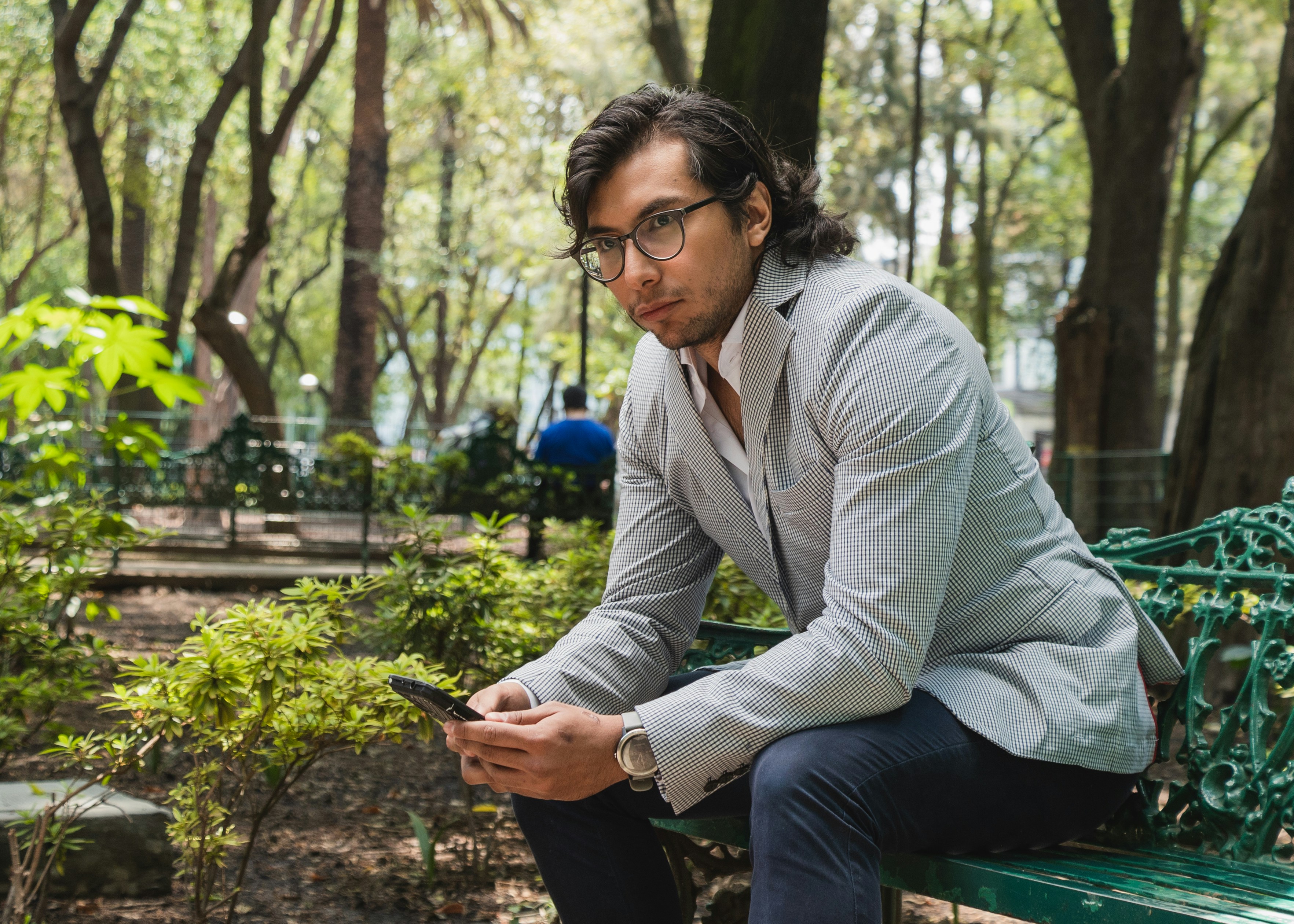 , Mexican male model in a modern suit posing in Mexico City outdoors sitting in a park bench with a thoughtful face.</p><p>Professional work by estudio2957.com 