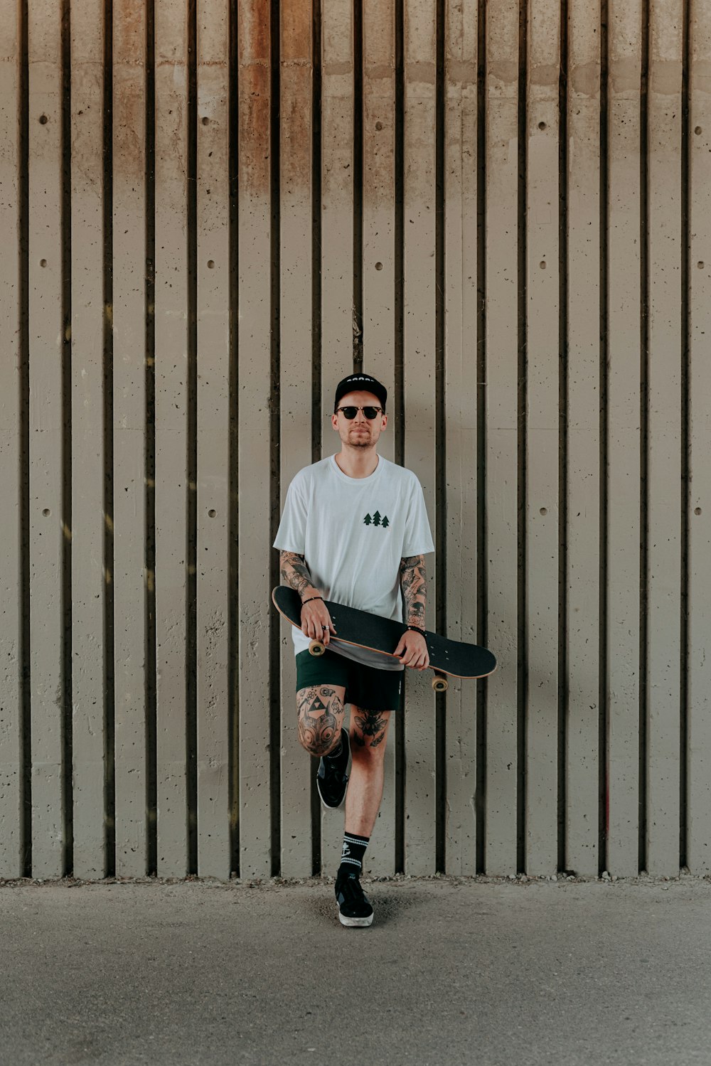 a man standing in front of a fence