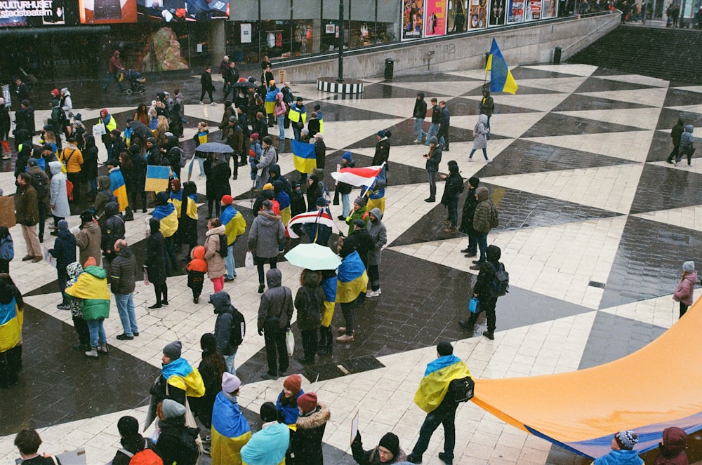 a crowd of people walking on a street