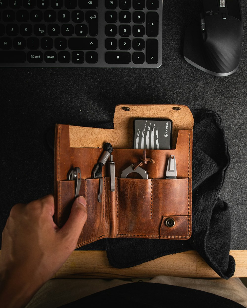 a hand holding a leather wallet