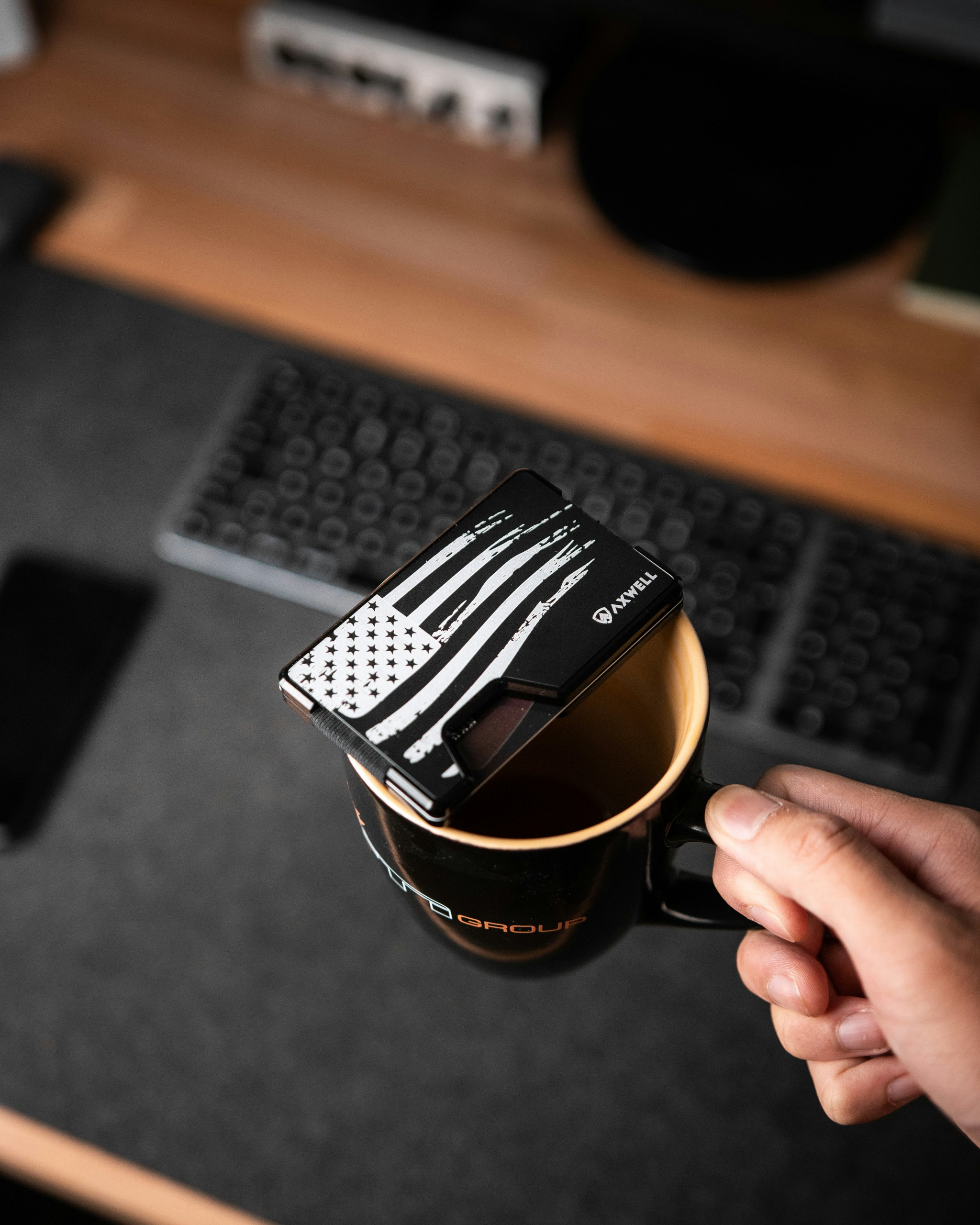 a hand holding a black watch