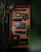 A collection of practical everyday items like multi-tools, flashlights, and compact first aid kits arranged neatly.