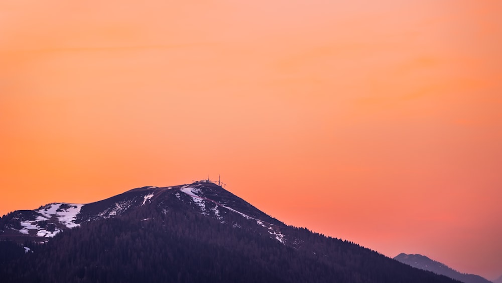 a mountain with a sunset in the background